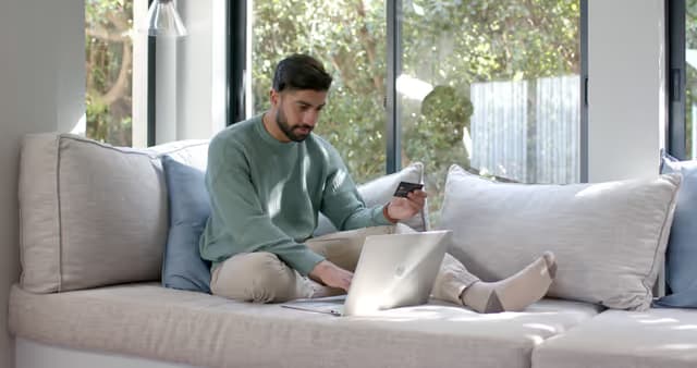 Person ordering from home on the couch.